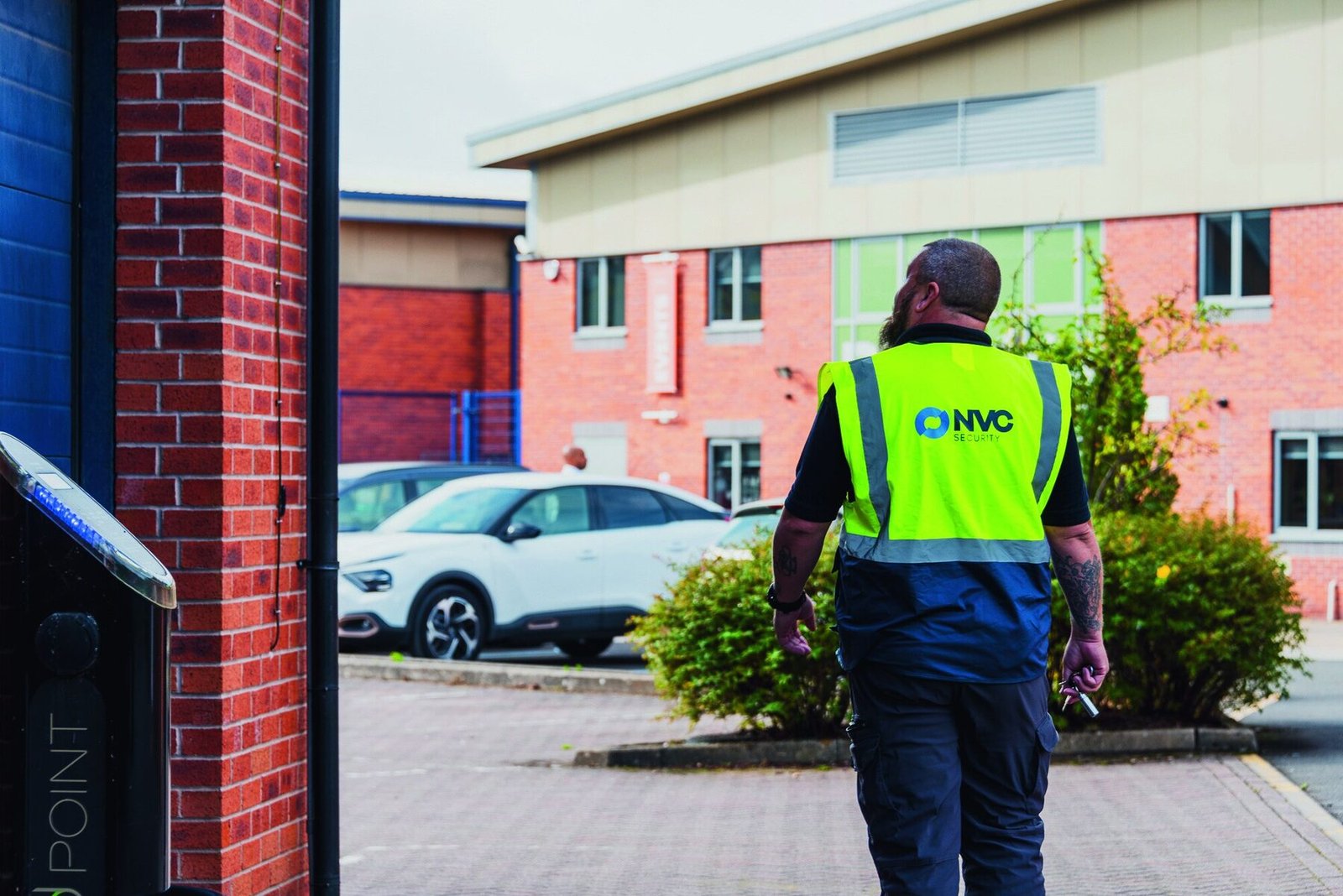 NVC officer in hi-vis walking to premises